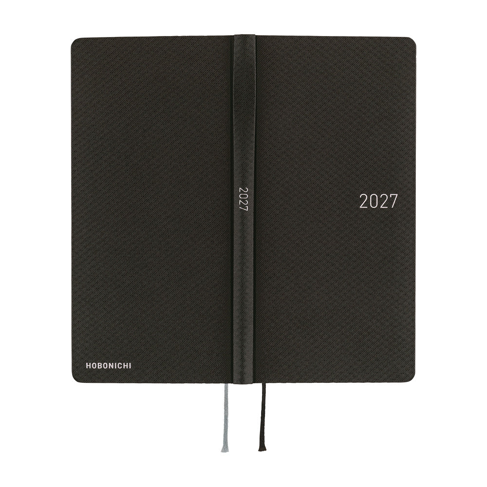 The exterior of a slim 2027 planner with a patterned black cover, featuring a silver-embossed '2027'.
