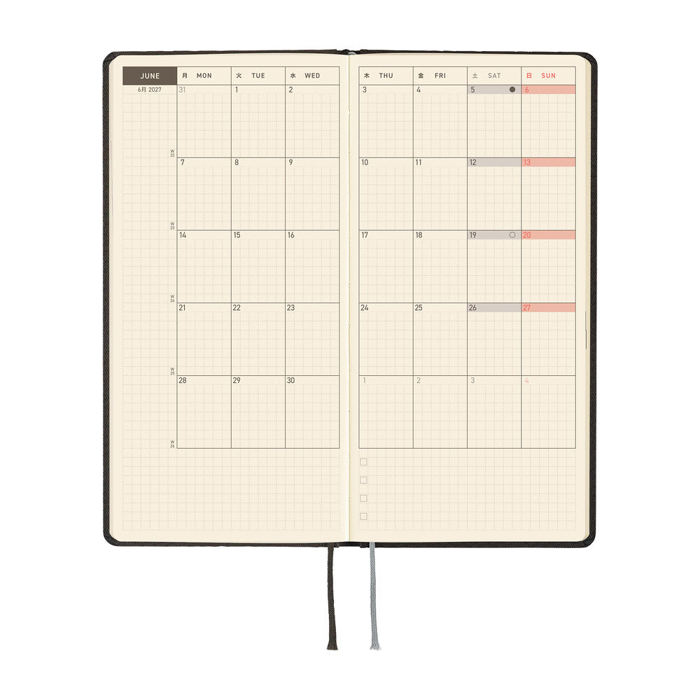 An open planner featuring a monthly two-page calendar on cream colored paper.