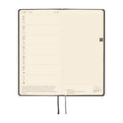 An open planner showing a two-page weekly spread. The left page shows a weekly schedule layout for June 21st through 27st while the right page has a grid for notetaking.