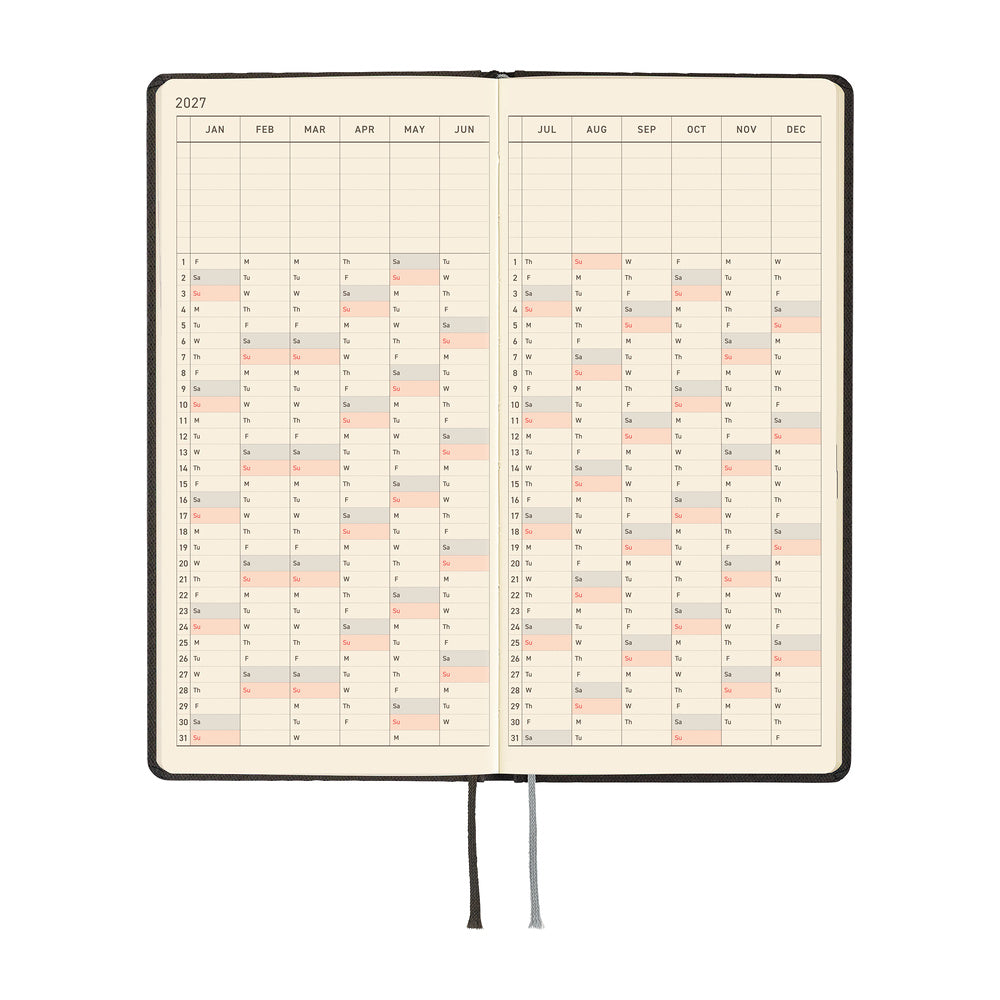 An open 2027 planner showing a yearly spread with cream colored pages. 
