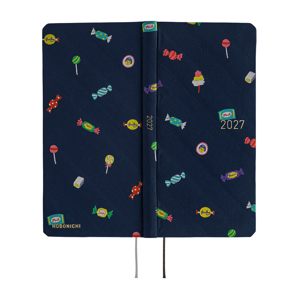 The exterior of a 2027 planner featuring an array of colorful candies woven into a dark navy blue necktie fabric. 