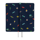 The exterior of a 2027 planner featuring an array of colorful candies woven into a dark navy blue necktie fabric. 