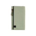 Front of light green fabric Tragen zippered cover for Hobonichi Techo Weeks planner on white background