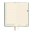 An open weekly planner with cream-colored pages and two ribbon bookmarks.