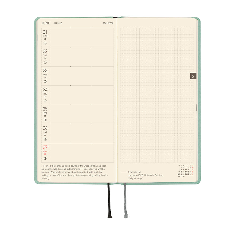 An open planner showing two interior pages: the left page has a weekly schedule layout for June 21st through 27st, and the right page has a grid.