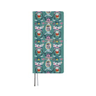 A planner with a teal cover featuring a repeating pattern of illustrated White Cat characters and geese, shown on a plain white background.
