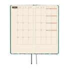An open planner or journal with a grid calendar layout showing June, on a white background.
