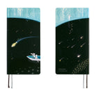 A front and back view of a planner with a cover that features illustrations of two cats in a rowboat on a field of black scattered with stars. 