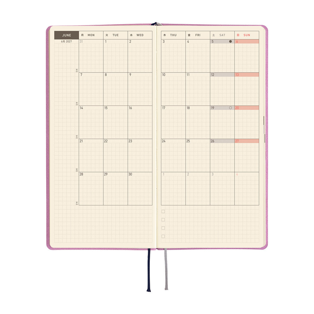 An planner showing a monthly calendar layout on warm cream pages.