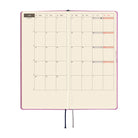An planner showing a monthly calendar layout on warm cream pages.