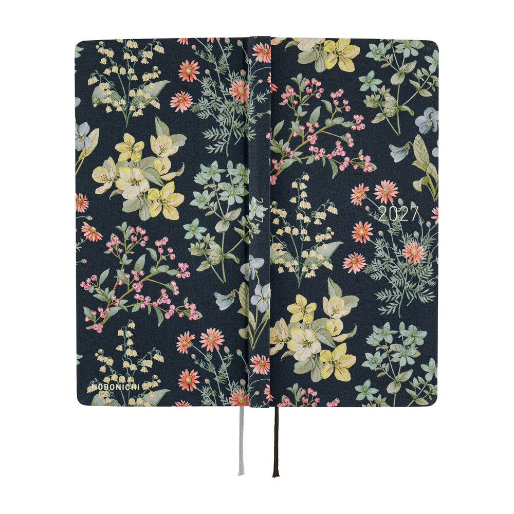 The exterior of a 2027 planner covered in fabric featuring a botanical design on a dark background by Liberty Fabrics. 