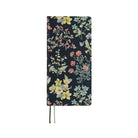 A 2027 planner covered in fabric featuring a botanical design on a dark background by Liberty Fabrics. 