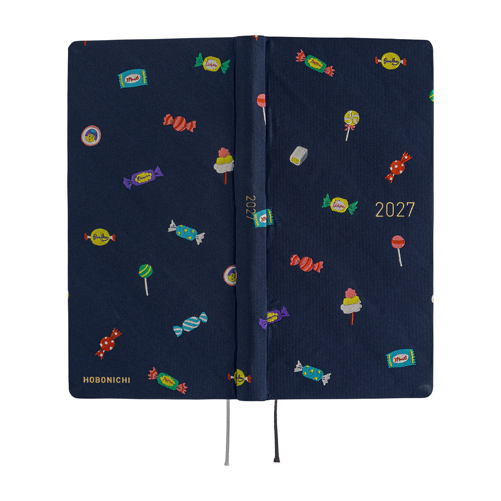 A 2027 Hobonichi Weeks Mega featuring Bow & Tie fabric woven with candy designs.