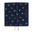 A 2027 Hobonichi Weeks Mega featuring Bow & Tie fabric woven with candy designs.