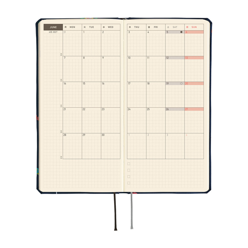 A 2027 Hobonichi Weeks Mega featuring Bow & Tie fabric woven with candy designs.