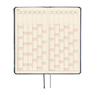 A 2027 Hobonichi Weeks Mega featuring Bow & Tie fabric woven with candy designs.
