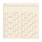 An open planner showing a yearly calendar laid out in a vertical format on cream-colored pages. 