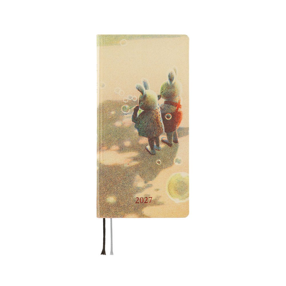 A 2027 planner featuring illustrations of two rabbits blowing bubbles, on a sandy colored background.