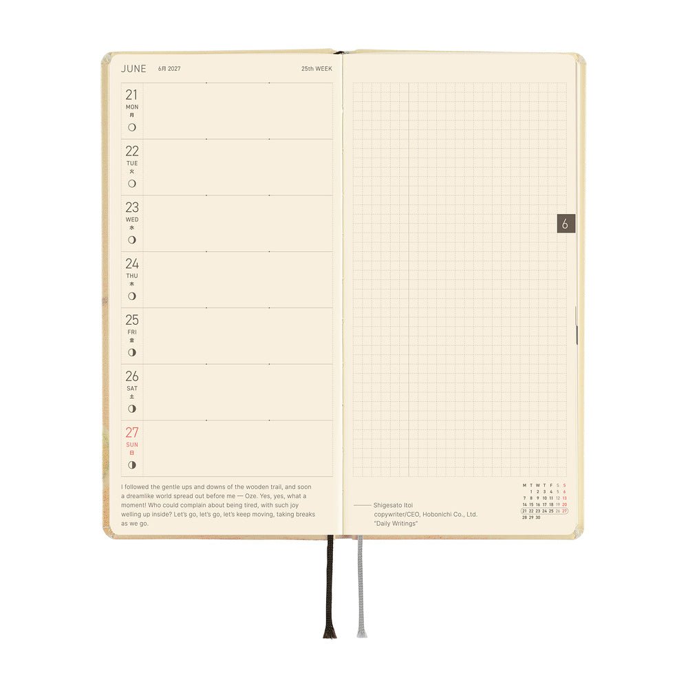 An open planner or notebook with cream-colored pages, showing a weekly layout on the left side and a grid section on the right. 