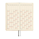 An open 2027 daily planner with cream-colored pages featuring a detailed yearly calendar grid.