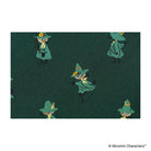 A close-up photo showing one of the Moomin characters woven into dark green fabric.