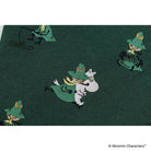 A close-up photo showing one of the Moomin characters woven into dark green fabric.