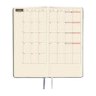 An open planner showing a two-page monthly calendar spread. 