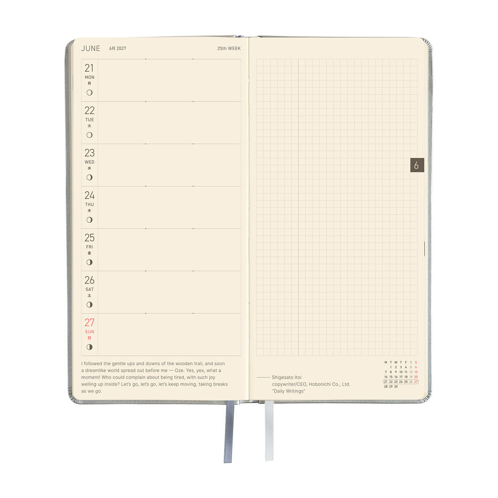 An open daily planner showing a two-page spread with a cream-colored left page featuring a weekly layout and a right page with a grid layout.