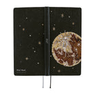 The exterior of a planner featuring a printed image of an embroidery piece crafted from countless beads, sequins, and jewels depicting the luminous moon surrounded by shining stars in the night sky.
