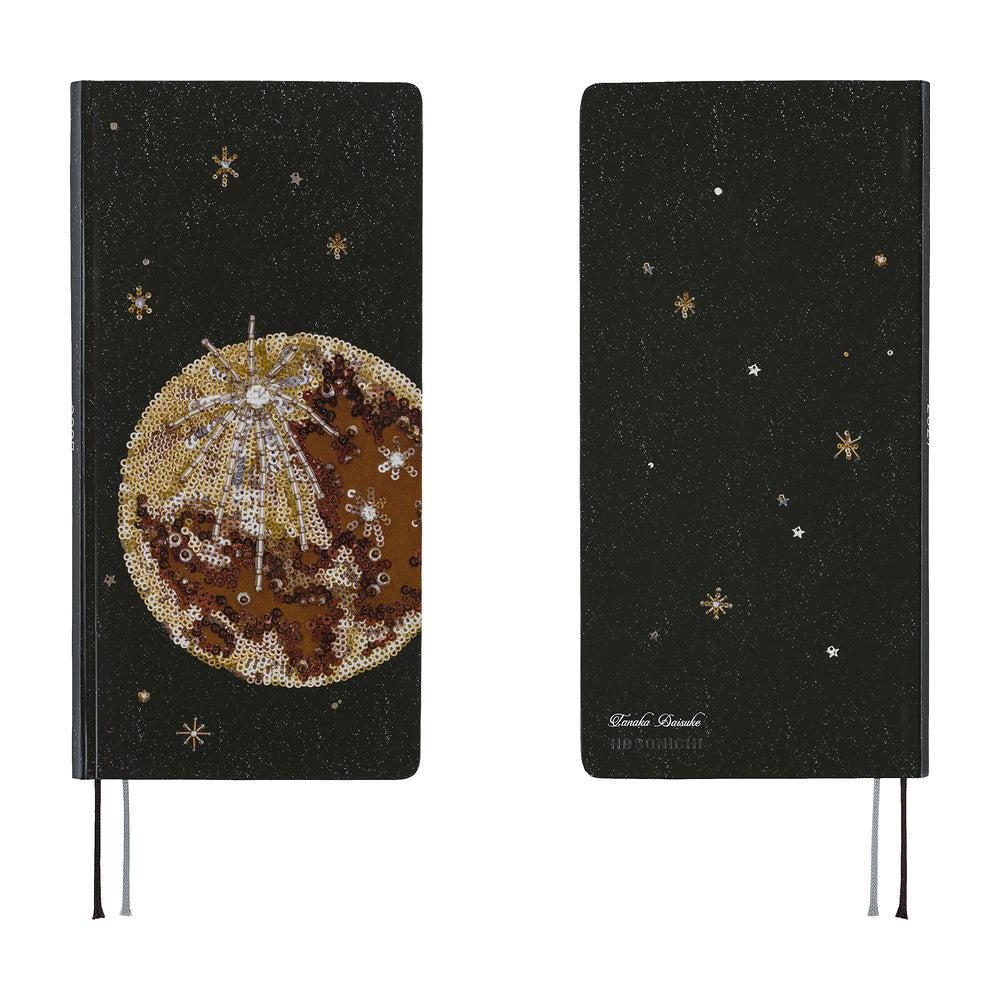 The front and back covers of a planner featuring a printed image of an embroidery piece crafted from countless beads, sequins, and jewels depicting the luminous moon surrounded by shining stars in the night sky.