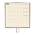 An open monthly planner with a two-page monthly calendar spread. 