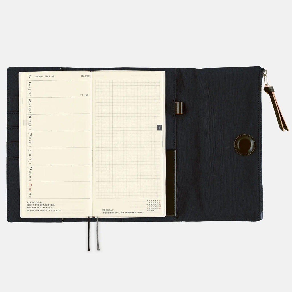 Black Hobonichi Techo Weeks Tragen cover with weekly planner on white background