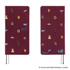 A front and back view of a 2027 journal covered in woven "bow & tie" fabric featuring icons from the Victoria & Albert museum collection, such as a crown, teapot, chair, and dress. 
