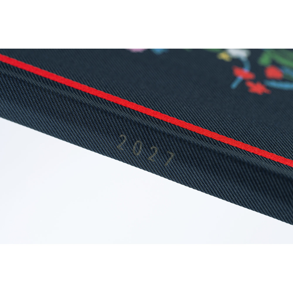 The spine of a navy blue planner, showing the year 2027. 