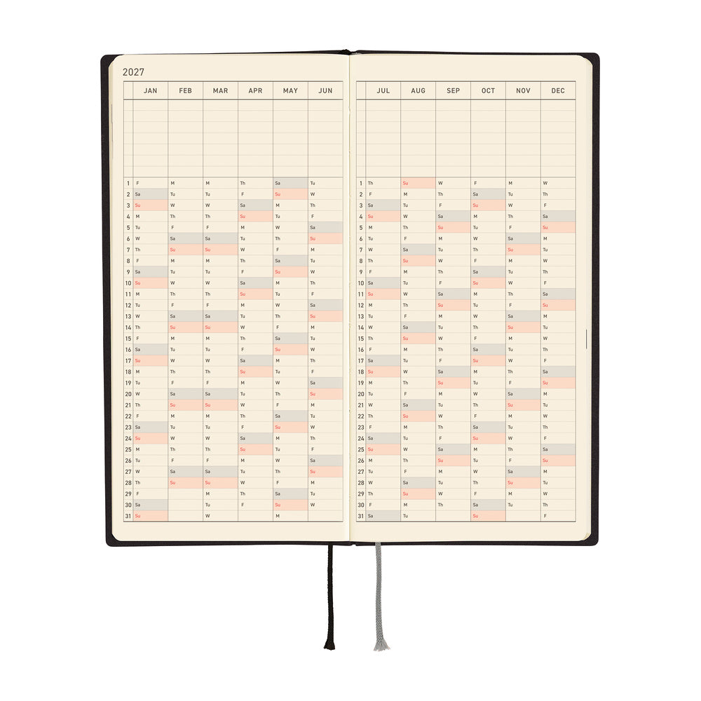 An open 2027 planner with cream-colored pages showing a yearly calendar grid, black binding, and two ribbon bookmarks, photographed on a solid white background.