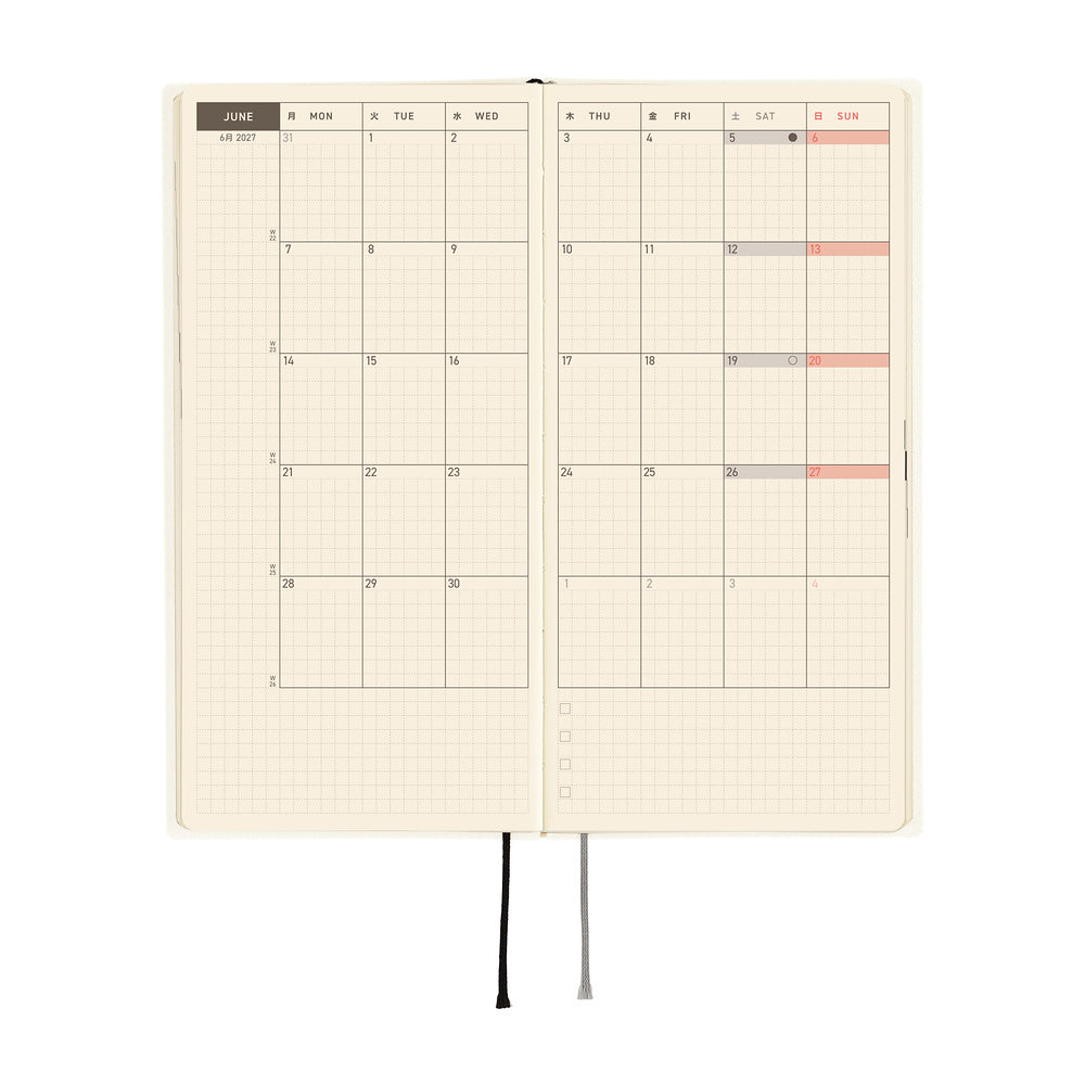 An open planner with a monthly calendar spreadsheet on cream grid paper, shown against a plain white background.