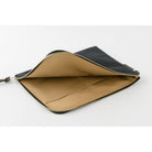 A black A5 zippered tragen flat pouch open with tan interior on white background