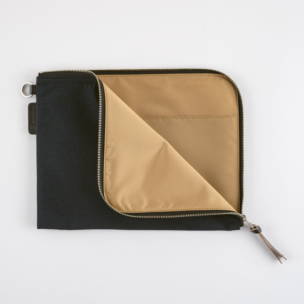 Black and beige zippered pouch on a white background