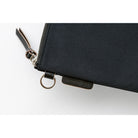 Black zippered pouch with a visible brand logo on a white background
