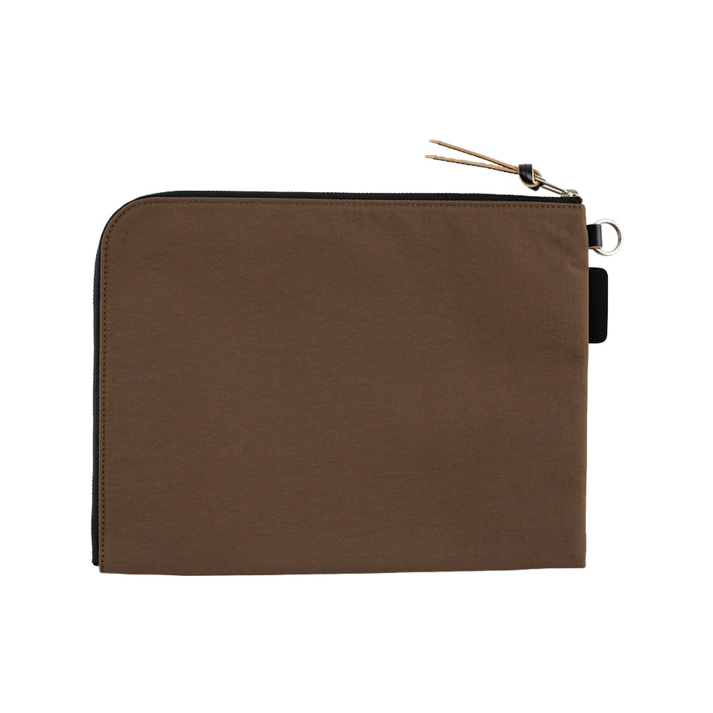 A brown A5 zippered tragen flat pouch closed on white background