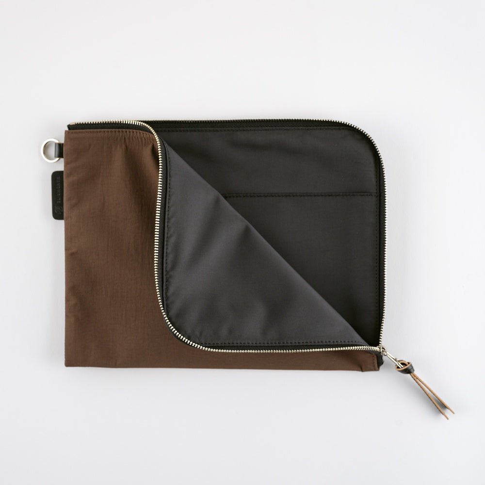 Brown and black zippered pouch on a white background