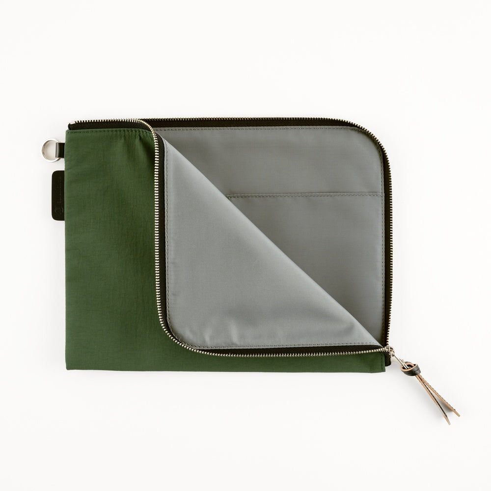 An olive green zippered pouch with a silver zipper and a gray interior lining, shown open on a plain white background.