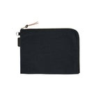 A black A6 zippered Tragen flat pouch on white background