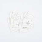 Four arched sheets of blotting paper shown on a clean white background. The papers feature minimalist black abstract line art and text detailing its features.