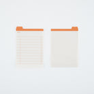 Two white planner inserts with orange tabs, shown on a clean white background. One insert features a lined table with checkboxes, and the other features a light grid pattern.