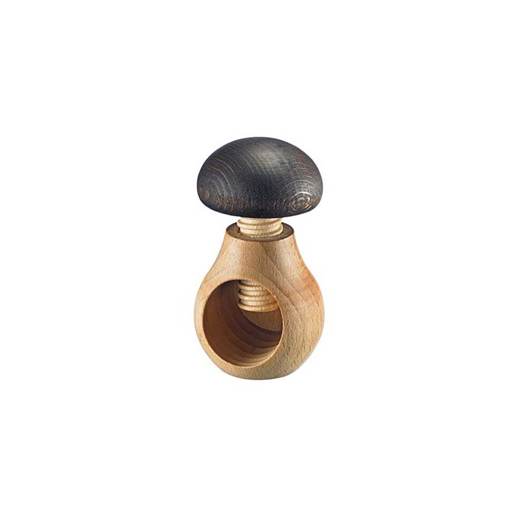 Wooden nutcracker with mushroom shaped design on white background