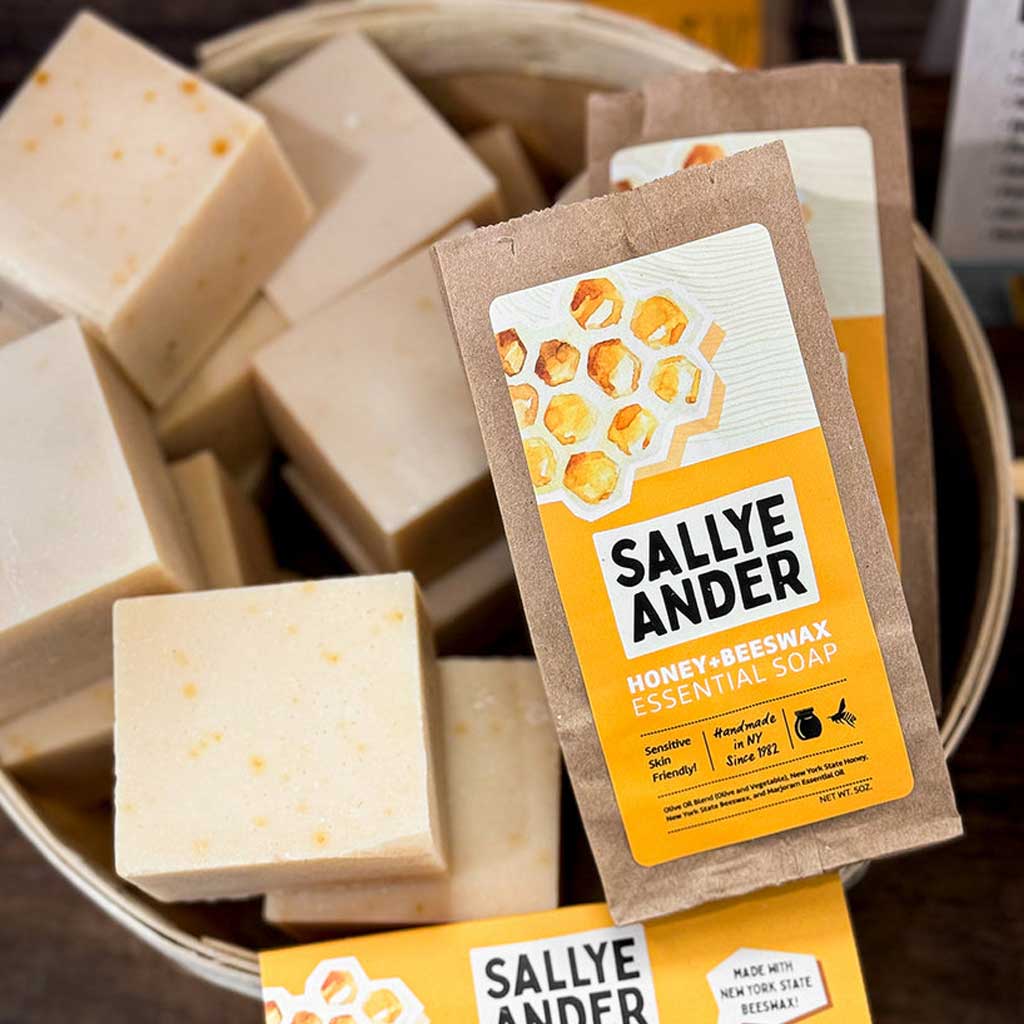 Sallye Ander honey beeswax soap bars with packaging in a basket.