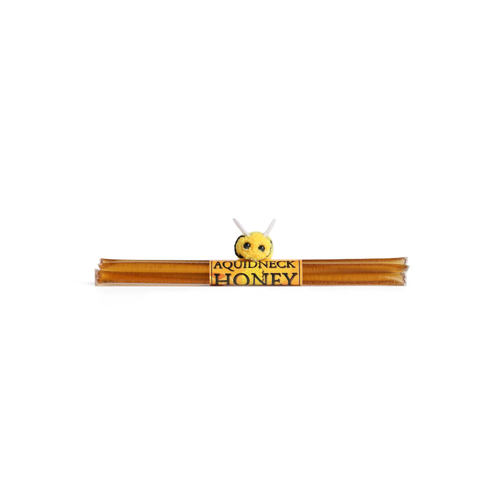 Pack of five New England honey straws with yellow Aquidneck Honey label and bee attached on white background