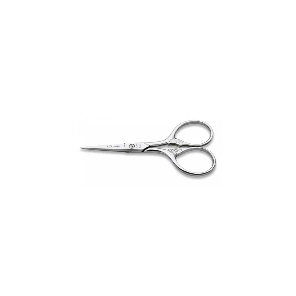 Pair of embroidery scissors with cornucopia design on white background