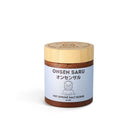 Jar of Onsen Saru hot spring salt scrub with wooden lid on a white background